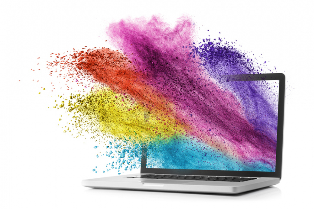 Laptop display screen exploding with colours